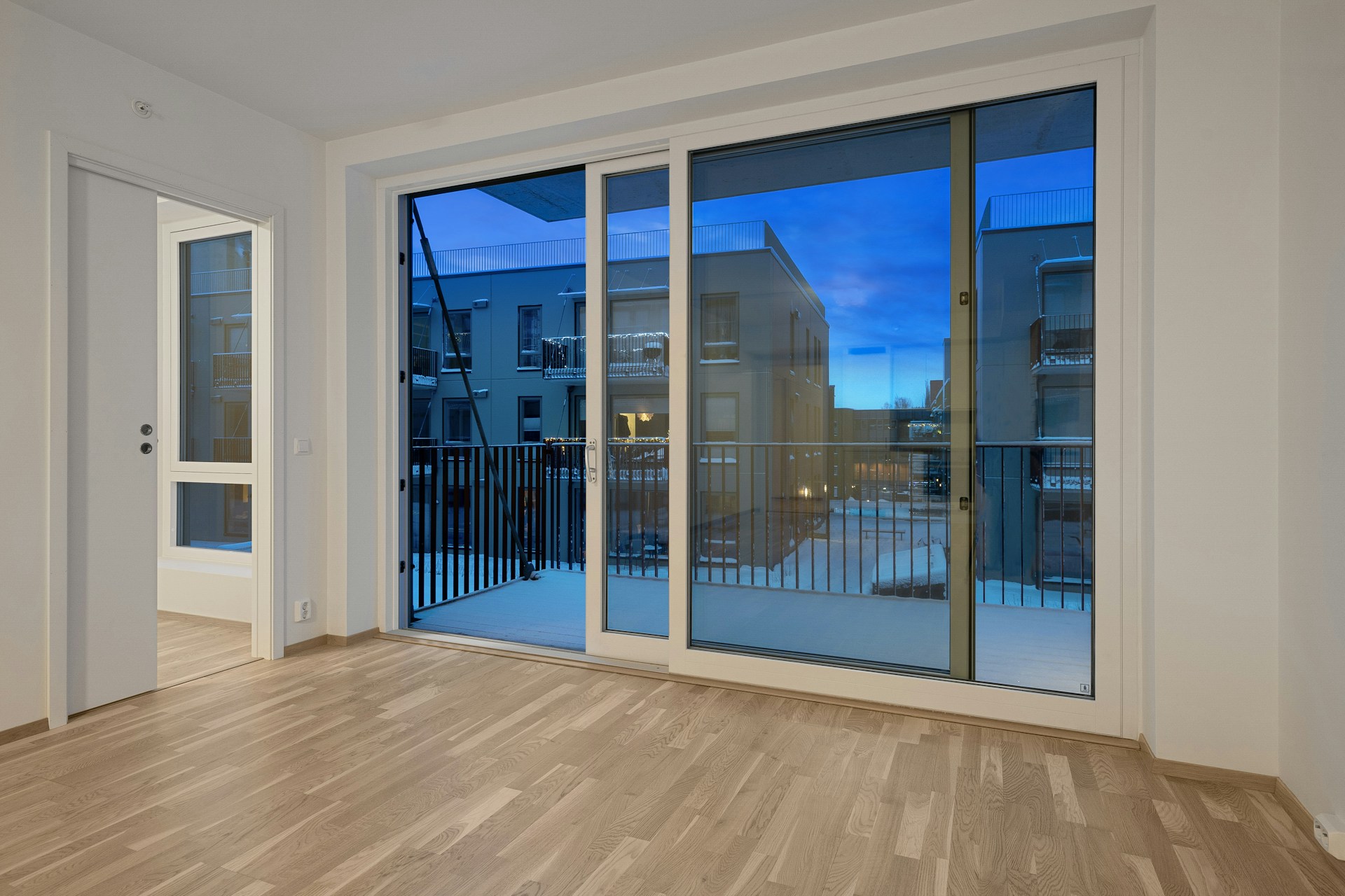 Aluminium sliding door with white frame in modern apartment